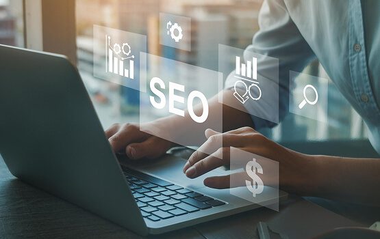 A close-up of a person's hands working on a laptop in a modern, light-filled office, illustrating the digital platform and user experience features.