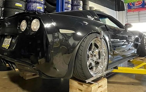 QuickTrick Alignment case study image showing a race car being fitted with alignment tools, highlighting the Custom Product Variation Module and Multiple Payment Gateways.