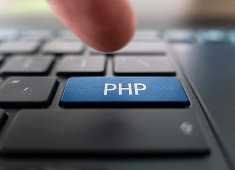 Custom PHP development company services concept with PHP key on keyboard for scalable web applications