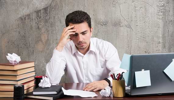 Image illustrating an agency owner's stress from being overworked and unable to handle a large project, contrasting with Wisitech's invisible production solution.