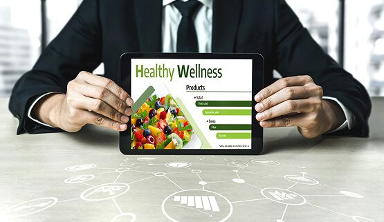 A vibrant display of fresh fruits and vegetables alongside a digital tablet displaying health information, symbolizing the intersection of nutrition and digital health education.