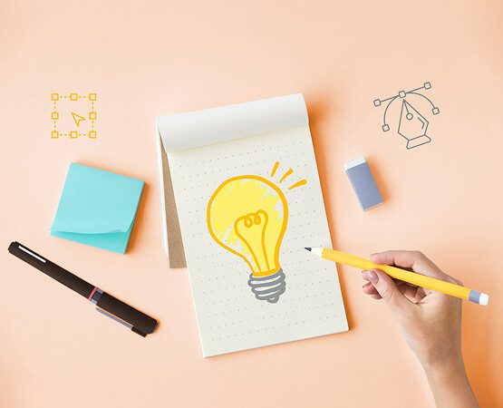 A hand drawing a lightbulb on a notepad, surrounded by sticky notes, symbolizing the strategic solution and creative digital marketing concepts delivered.